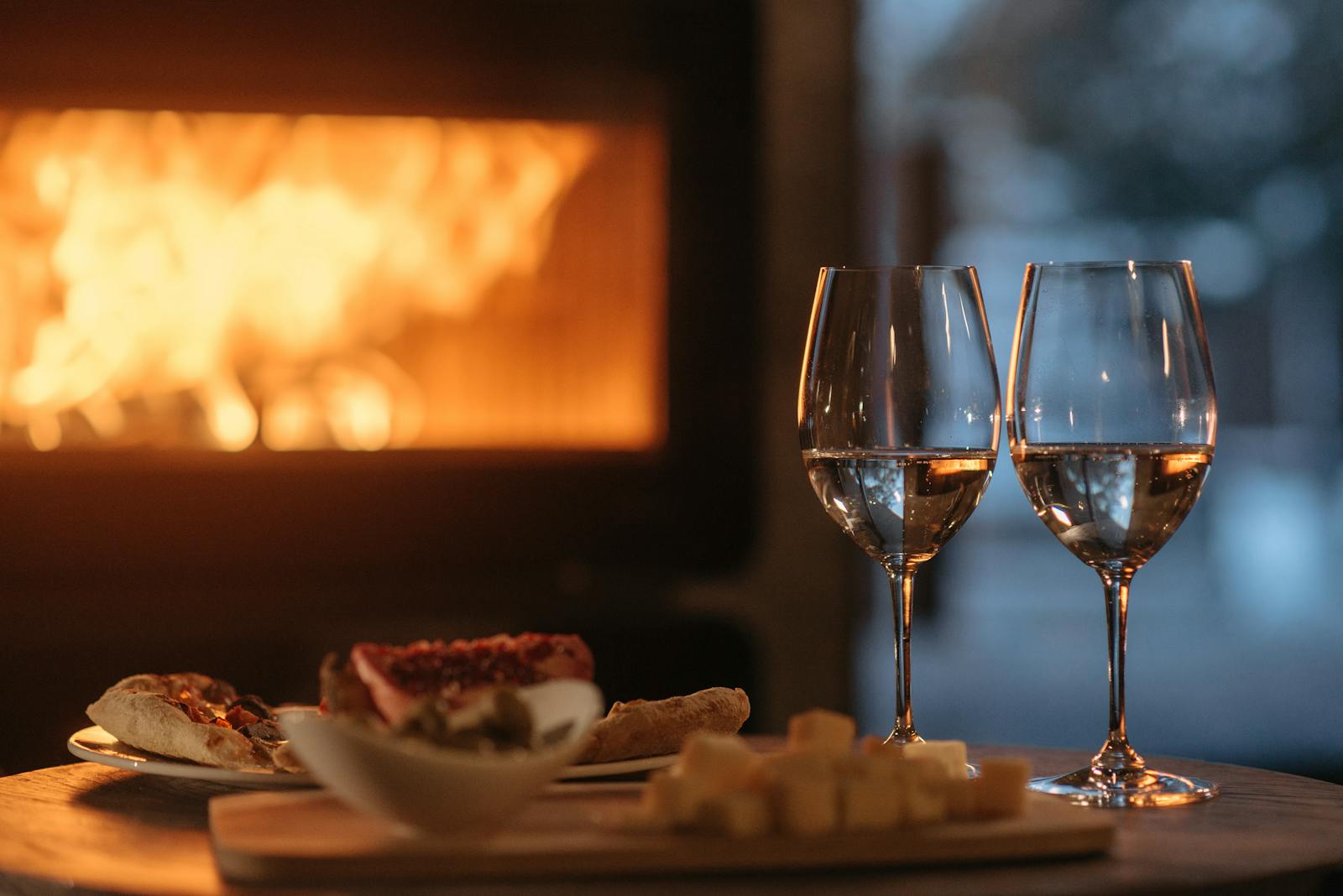 Clear Wine Glass Beside White Ceramic Plate With Food